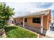 Spacious backyard with a covered patio, lawn, and garden, offering a serene outdoor space at 9329 Mountain Cliffs Ave, Las Vegas, NV 89129