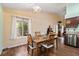 Bright dining area featuring wood-look floors, a window, and adjacent kitchen features at 9329 Mountain Cliffs Ave, Las Vegas, NV 89129