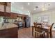 Charming kitchen features dark wood cabinets and stainless steel appliances with dining table at 9329 Mountain Cliffs Ave, Las Vegas, NV 89129
