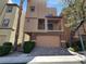 Modern two-story home featuring a brick facade, covered balcony, and a two-car garage at 9384 Hosner St, Las Vegas, NV 89178