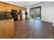 Spacious kitchen with black appliances, wooden cabinets, and access to an outdoor balcony at 9384 Hosner St, Las Vegas, NV 89178