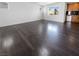 Spacious living room with dark hardwood floors, bright lighting, and large windows offering serene neighborhood views at 9384 Hosner St, Las Vegas, NV 89178