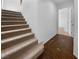Staircase with carpeted steps and a brown tiled hallway at 9384 Hosner St, Las Vegas, NV 89178