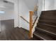 Modern staircase with wooden steps, metal railings, and wood flooring, creating an elegant transition between levels at 9384 Hosner St, Las Vegas, NV 89178