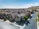 Aerial view of a tan two-story home in a residential neighborhood with mountain views at 9713 Kampsville Ave, Las Vegas, NV 89148