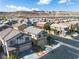 Aerial view of a grey two-story home with mountain views in a residential neighborhood at 9713 Kampsville Ave, Las Vegas, NV 89148