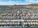 Aerial view of a well-planned residential community near mountains, featuring orderly streets and uniform housing at 9713 Kampsville Ave, Las Vegas, NV 89148