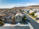 Aerial view of a tan two-story home with mountain views in a residential neighborhood at 9713 Kampsville Ave, Las Vegas, NV 89148
