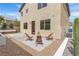 The backyard features a concrete patio, planters, bench, and three wooden chairs at 9713 Kampsville Ave, Las Vegas, NV 89148