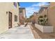 This backyard features a concrete patio, planters, and two wood chairs for relaxing outdoors at 9713 Kampsville Ave, Las Vegas, NV 89148