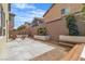This backyard features a concrete patio, planters, a bench and wood chairs for relaxing at 9713 Kampsville Ave, Las Vegas, NV 89148