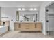 Bright bathroom with double vanity, modern fixtures, and a soaking tub at 9713 Kampsville Ave, Las Vegas, NV 89148