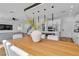Open-concept design features a wood table and seamlessly integrates the kitchen and living area at 9713 Kampsville Ave, Las Vegas, NV 89148