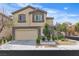 Two-story home featuring a two-car garage, manicured landscaping, and neutral color palette at 9713 Kampsville Ave, Las Vegas, NV 89148