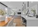 Bright, open kitchen with island, black pendant lights, and seamless flow to living area at 9713 Kampsville Ave, Las Vegas, NV 89148