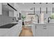 Bright kitchen featuring a large island, modern lighting, and open dining area at 9713 Kampsville Ave, Las Vegas, NV 89148