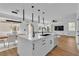 Modern kitchen with large island, pendant lighting, and an open floorplan at 9713 Kampsville Ave, Las Vegas, NV 89148