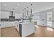 Contemporary kitchen with stainless steel appliances, white cabinetry, and an island with seating at 9713 Kampsville Ave, Las Vegas, NV 89148