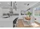 Open concept kitchen and dining area with island seating and modern fixtures at 9713 Kampsville Ave, Las Vegas, NV 89148