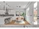 Open concept kitchen with modern fixtures with dining table seating six at 9713 Kampsville Ave, Las Vegas, NV 89148