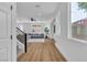 Bright living room with hardwood floors, large windows, and a comfortable gray sofa at 9713 Kampsville Ave, Las Vegas, NV 89148