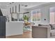 Bright living room with wood floors, a gray couch, and a view of the modern kitchen and dining area at 9713 Kampsville Ave, Las Vegas, NV 89148