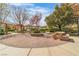 Charming neighborhood park featuring stone picnic table, mature trees and manicured hedges. Quiet common area at 9713 Kampsville Ave, Las Vegas, NV 89148