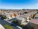Wide angle view of a well-maintained neighborhood, with a variety of single-Gathering homes in neutral tones and blue sky at 9713 Kampsville Ave, Las Vegas, NV 89148