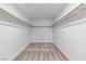 A spacious walk-in closet with double hanging rods, offering ample storage and organization space at 9713 Kampsville Ave, Las Vegas, NV 89148
