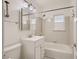 Well-lit bathroom with tiled shower-tub, mirrored cabinet, and a classic white finish at 103 W Victory Rd, Henderson, NV 89015