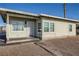 Charming single-story house featuring a secure front door, well-lit entrance, and cozy design at 103 W Victory Rd, Henderson, NV 89015
