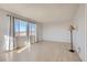 Bright living room with hardwood floors, neutral walls, and plenty of natural light from the large windows at 103 W Victory Rd, Henderson, NV 89015