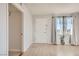 Bright living room with hardwood floors, neutral walls, and large windows with curtains at 103 W Victory Rd, Henderson, NV 89015