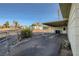 Side view of covered patio, blending seamlessly with the fenced backyard and surrounding greenery at 103 W Victory Rd, Henderson, NV 89015
