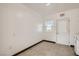 Clean, minimalist room with tile flooring, white walls, and ample lighting at 103 W Victory Rd, Henderson, NV 89015