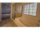 Bathroom with glass shower, soaking tub, large window, and view to a bedroom with ceiling fan at 1030 Country Skies Ave, Las Vegas, NV 89123