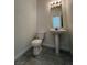 Powder room featuring a pedestal sink, tiled floor, and a modern mirror with lighting at 1030 Country Skies Ave, Las Vegas, NV 89123