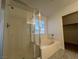 Bathroom showcases a glass shower, a soaking tub under a window, and a view to the walk-in closet at 1030 Country Skies Ave, Las Vegas, NV 89123
