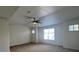 Spacious bedroom features a modern ceiling fan, neutral carpet, and natural light from the windows at 1030 Country Skies Ave, Las Vegas, NV 89123
