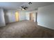 Spacious bedroom with neutral carpet and multiple doors leading to other areas of the home at 1030 Country Skies Ave, Las Vegas, NV 89123