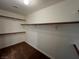 Walk-in closet featuring built-in shelving and carpet flooring, offering ample storage space at 1030 Country Skies Ave, Las Vegas, NV 89123