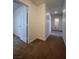 Carpeted hallway with a door leading to a bathroom at 1030 Country Skies Ave, Las Vegas, NV 89123