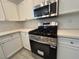 Close up of a modern kitchen with white cabinets and stainless steel appliances at 1030 Country Skies Ave, Las Vegas, NV 89123