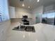 Modern kitchen with white cabinets, stainless steel appliances, and ample counter space at 1030 Country Skies Ave, Las Vegas, NV 89123