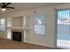 Bright living room with a fireplace, built-in shelves, and sliding doors leading to the outside at 1030 Country Skies Ave, Las Vegas, NV 89123