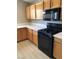 Functional kitchen with wood cabinets, durable countertops, and black appliances at 10342 Spider Rock Ave, Las Vegas, NV 89135