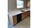 A well lit kitchen shows the light wood color cabinets, stainless steel sink and quartz countertops at 10342 Spider Rock Ave, Las Vegas, NV 89135