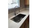 Stainless steel sink with pull down faucet and white countertops at 10342 Spider Rock Ave, Las Vegas, NV 89135