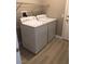 Bright laundry room with full-size washer and dryer and laminate flooring at 10342 Spider Rock Ave, Las Vegas, NV 89135