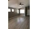 Bright living room boasts wood-look floors, neutral walls, and multiple windows for natural light at 10342 Spider Rock Ave, Las Vegas, NV 89135